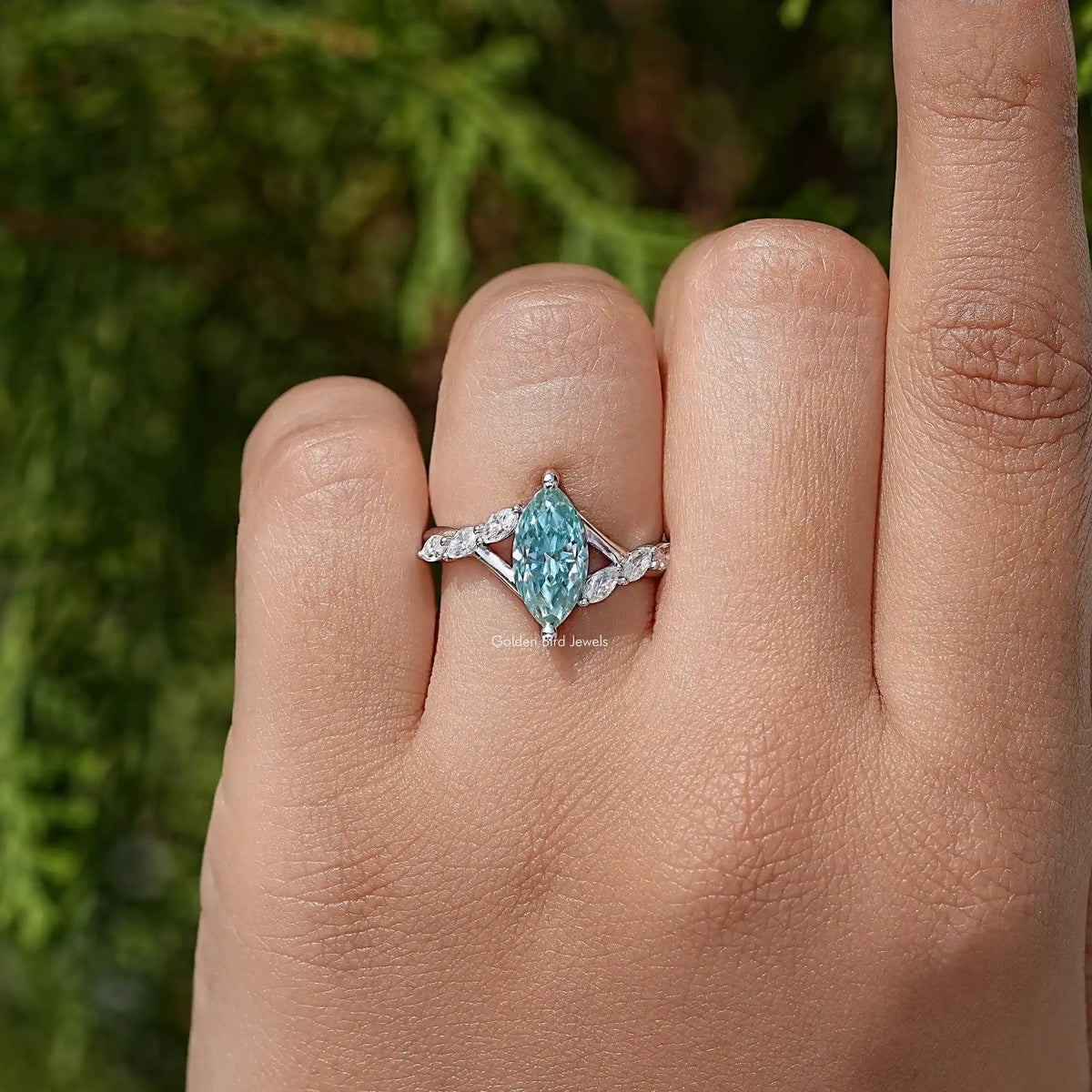 Teal marquise gemstone floral wedding ring with side stones, sterling silver band on finger