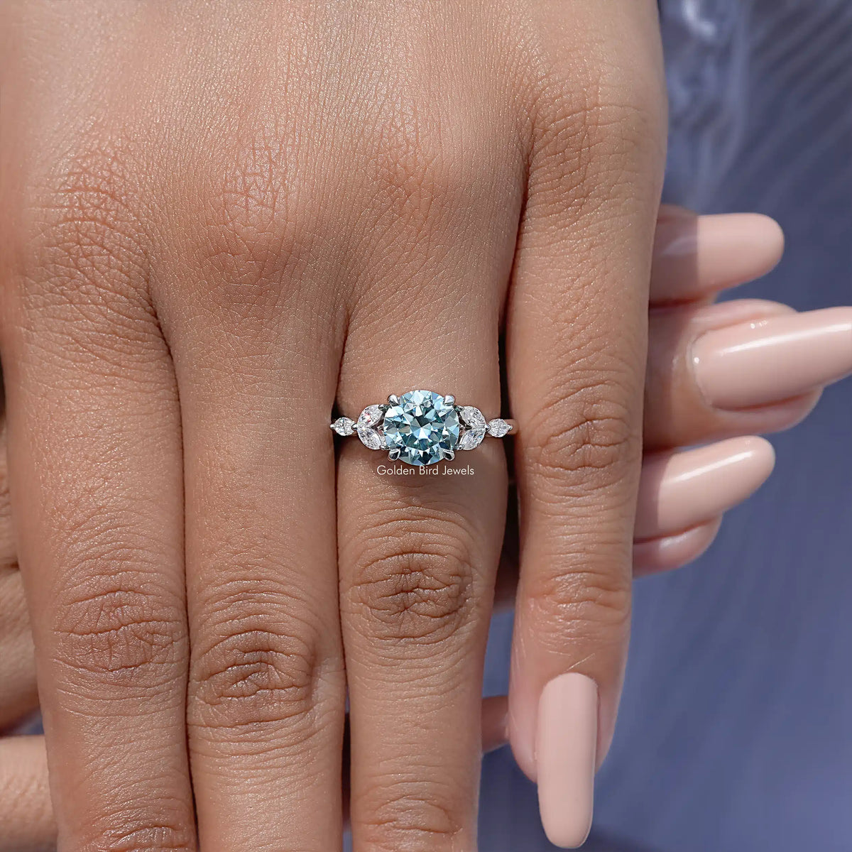 Moissanite engagement ring on finger, sterling silver band with round center stone