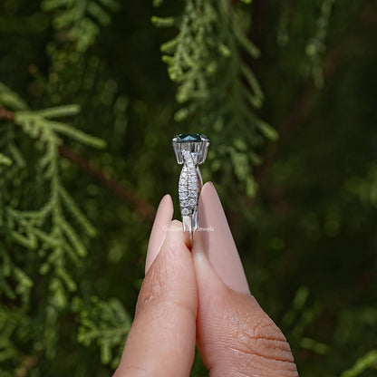 Green round moissanite ring with twisted pavé band, side view