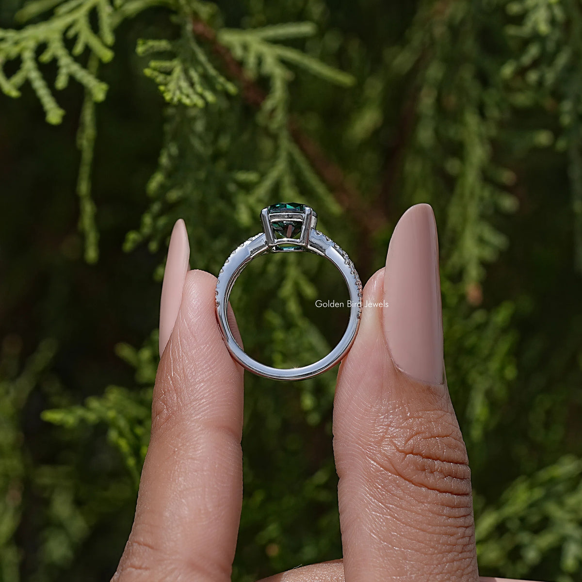 Green round moissanite ring with twisted accent setting, side view