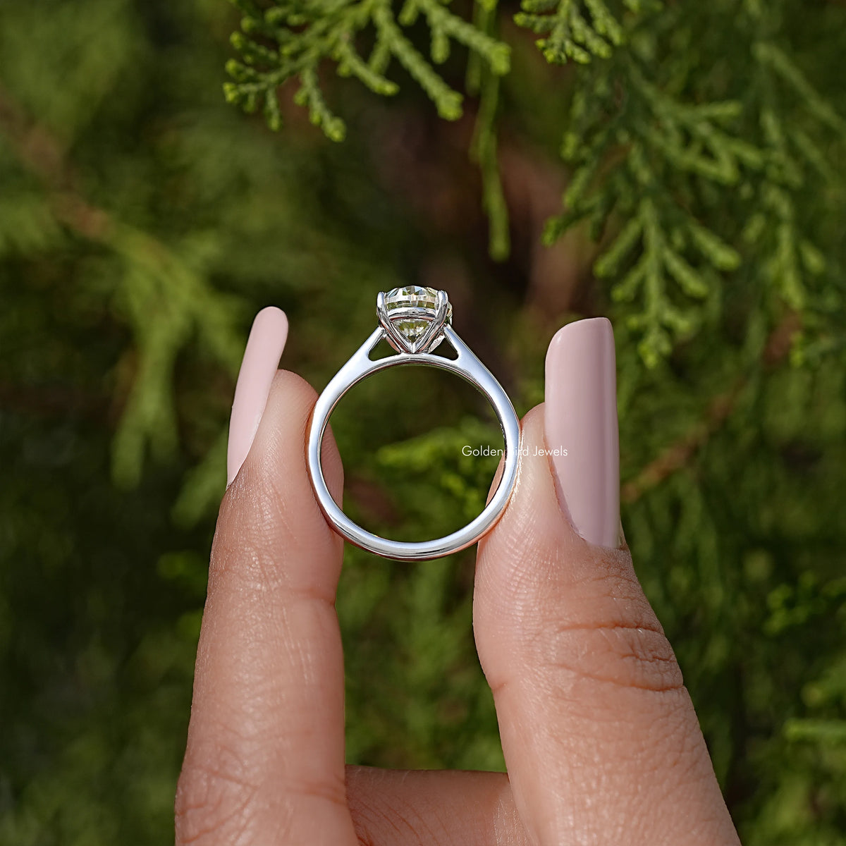 Silver oval moissanite solitaire ring, front view of band and prong-set oval stone