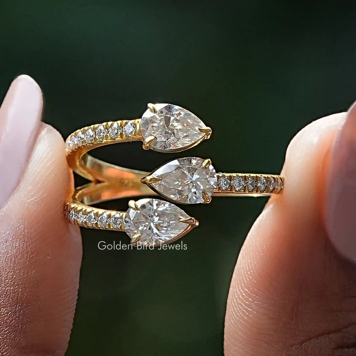 Gold open cuff band ring with pear-cut stones and pave accents