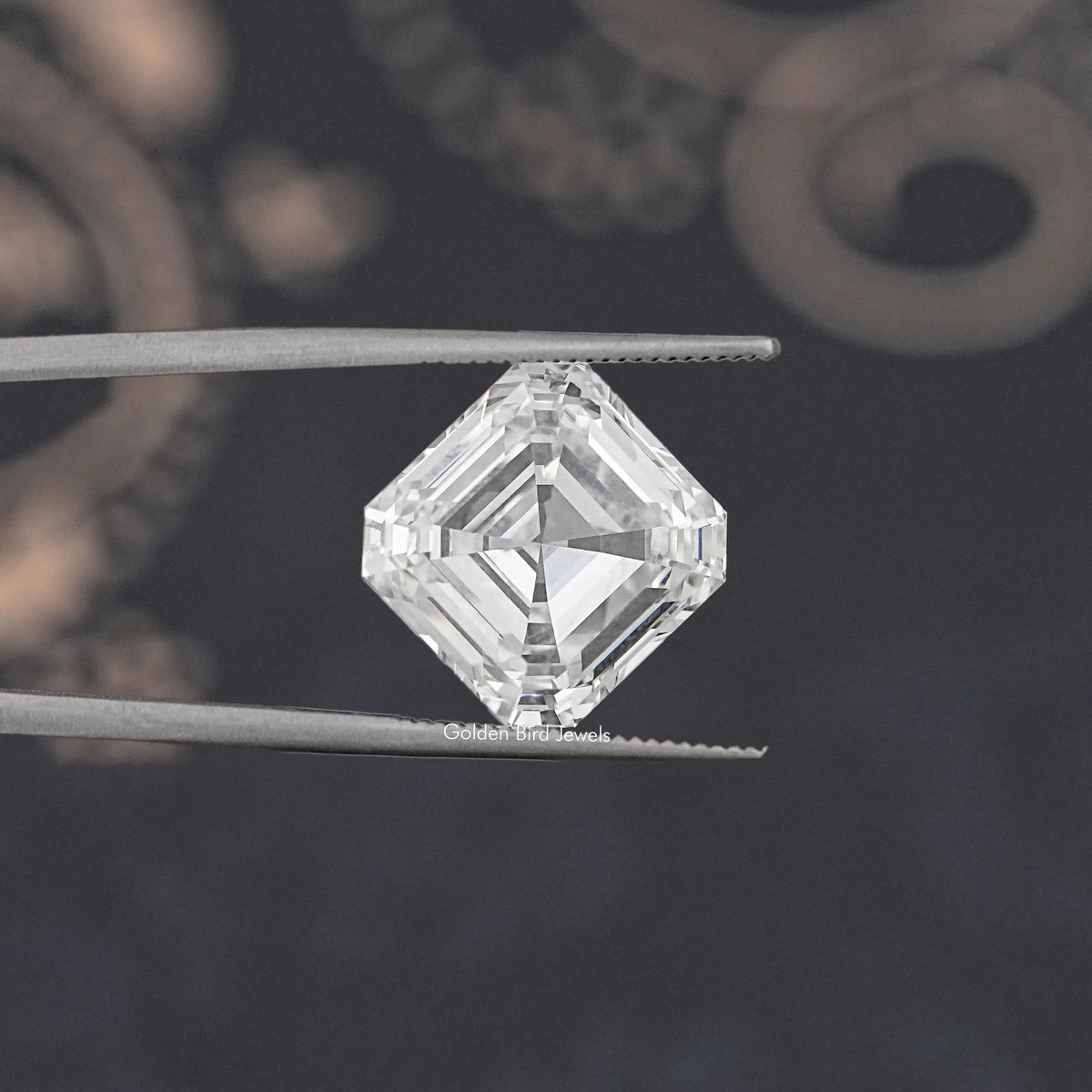 Asscher-cut lab-grown diamond in tweezers, clear step-cut stone