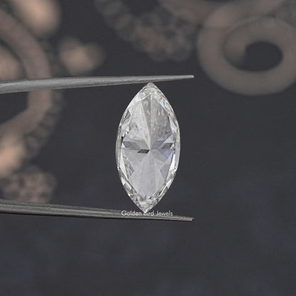 Marquise-cut loose lab-grown diamond close-up held on metal tweezers, bright white