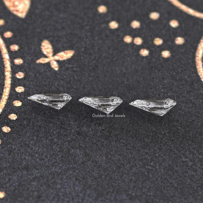 Set of three loose pear-cut lab diamonds, clear white with faceted sparkle
