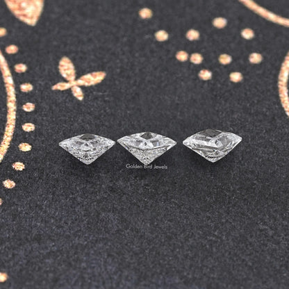 Three princess-cut lab-grown diamonds on dark felt, angled view