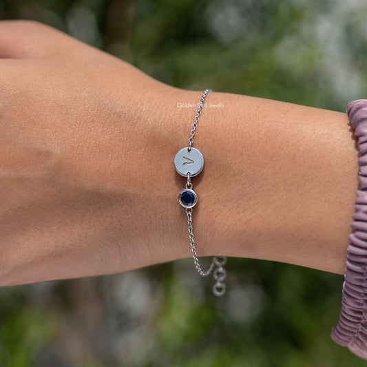Sterling silver bracelet with round light blue initial A charm and dark blue gemstone drop