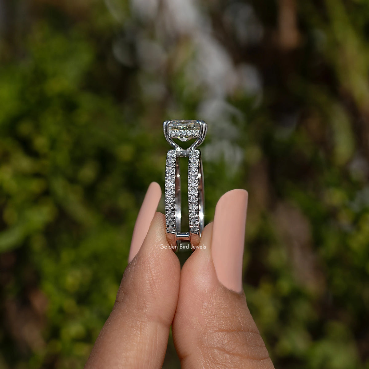 Moissanite ring with cushion-cut center stone and pavé split shank, side view