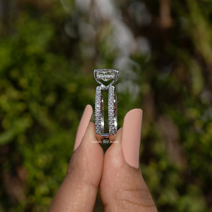 Moissanite ring with cushion-cut center stone and pavé split shank, side view