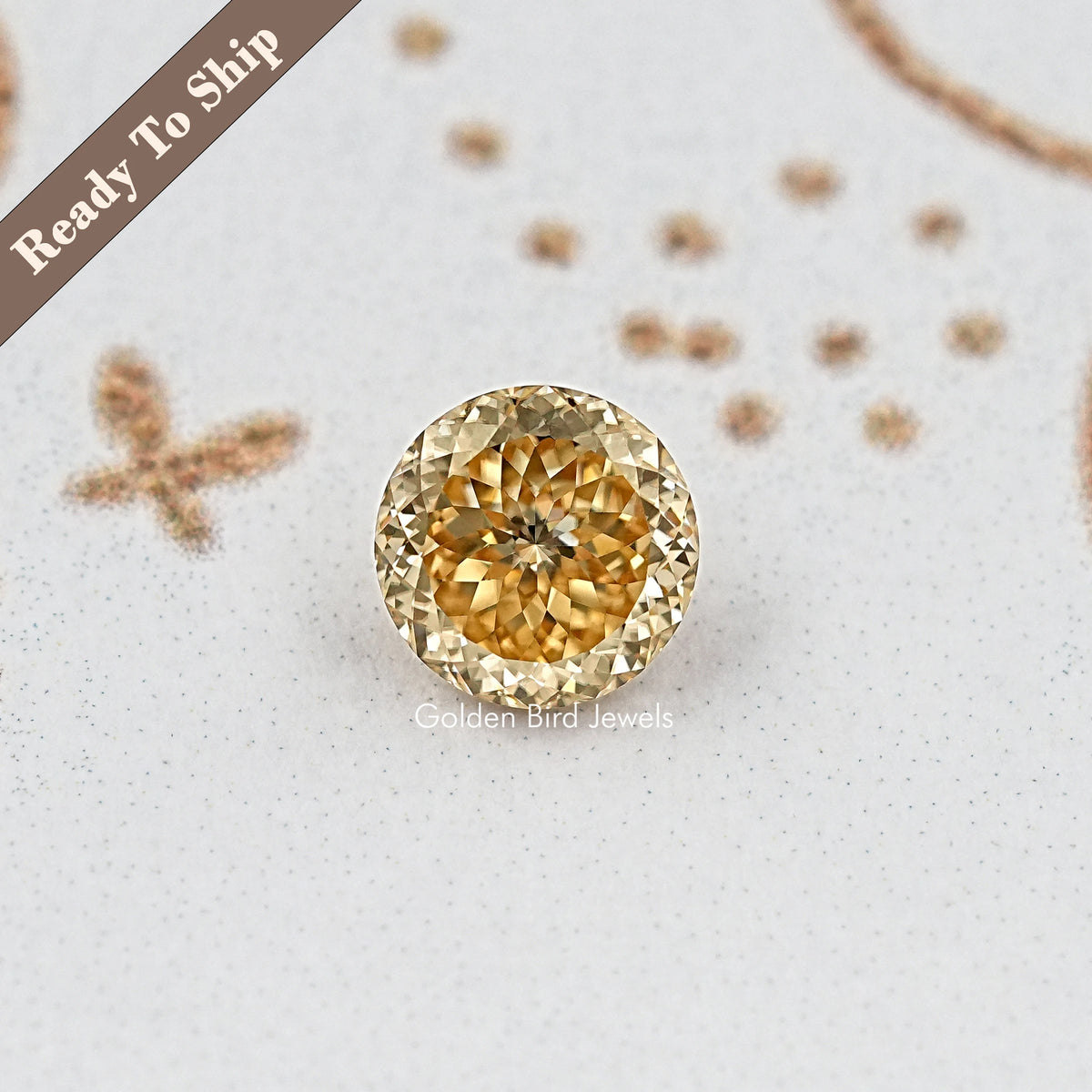 Round golden moissanite gemstone with detailed facets, front view
