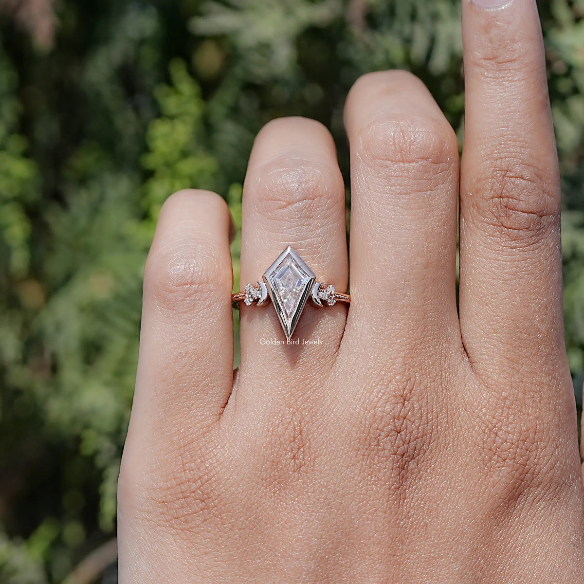 Rose-gold kite-cut moissanite ring on hand with marquise-like side accents