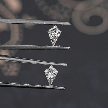Kite-cut lab-grown diamonds held in silver tweezers, close-up