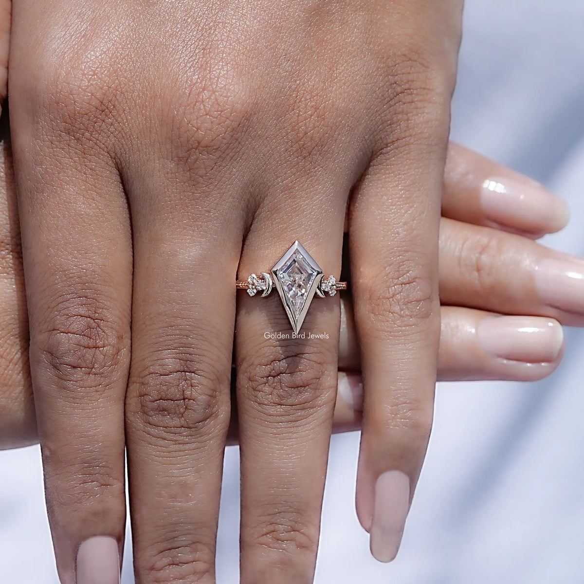 Rose-gold kite-cut moissanite bezel set ring with small round side stones