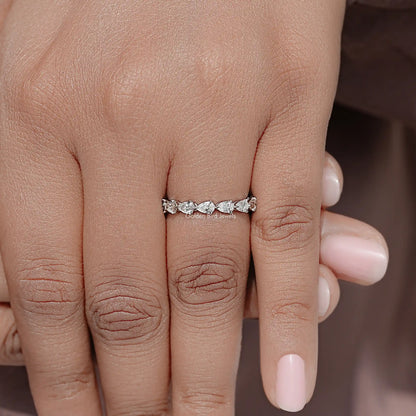 Pear-cut diamond eternity band on finger, slim silver band with continuous stones