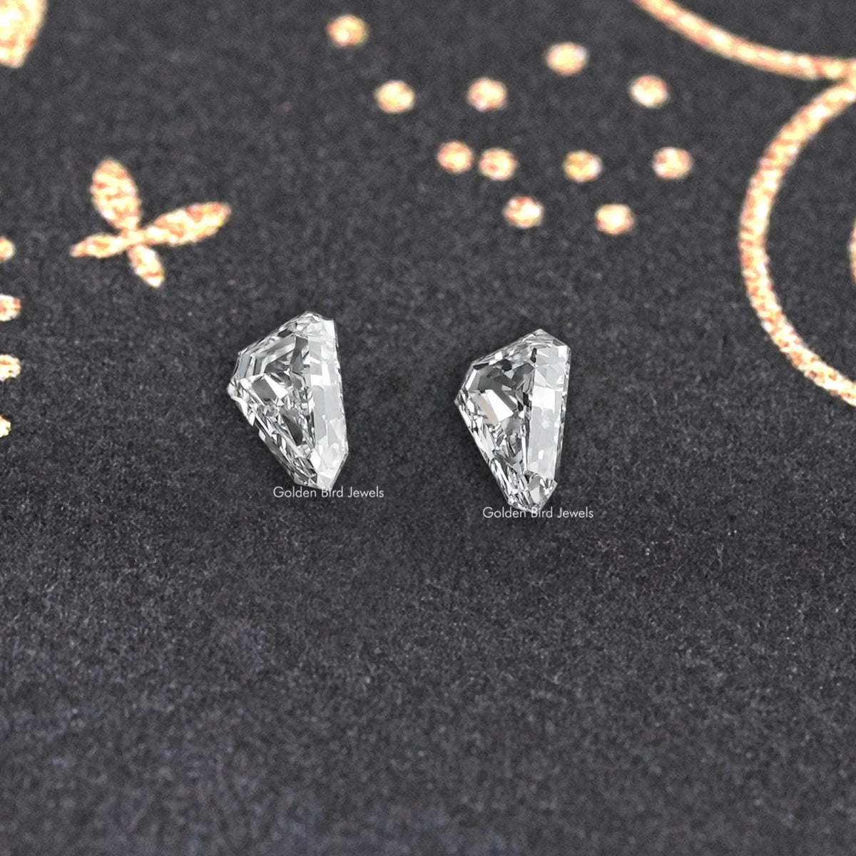 Arrow-cut lab-grown diamond pair, close view of two clear facet faces