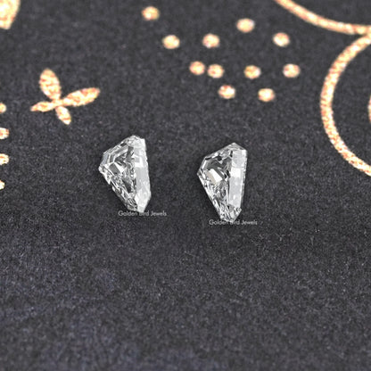 Arrow-cut lab-grown diamond pair, close view of two clear facet faces