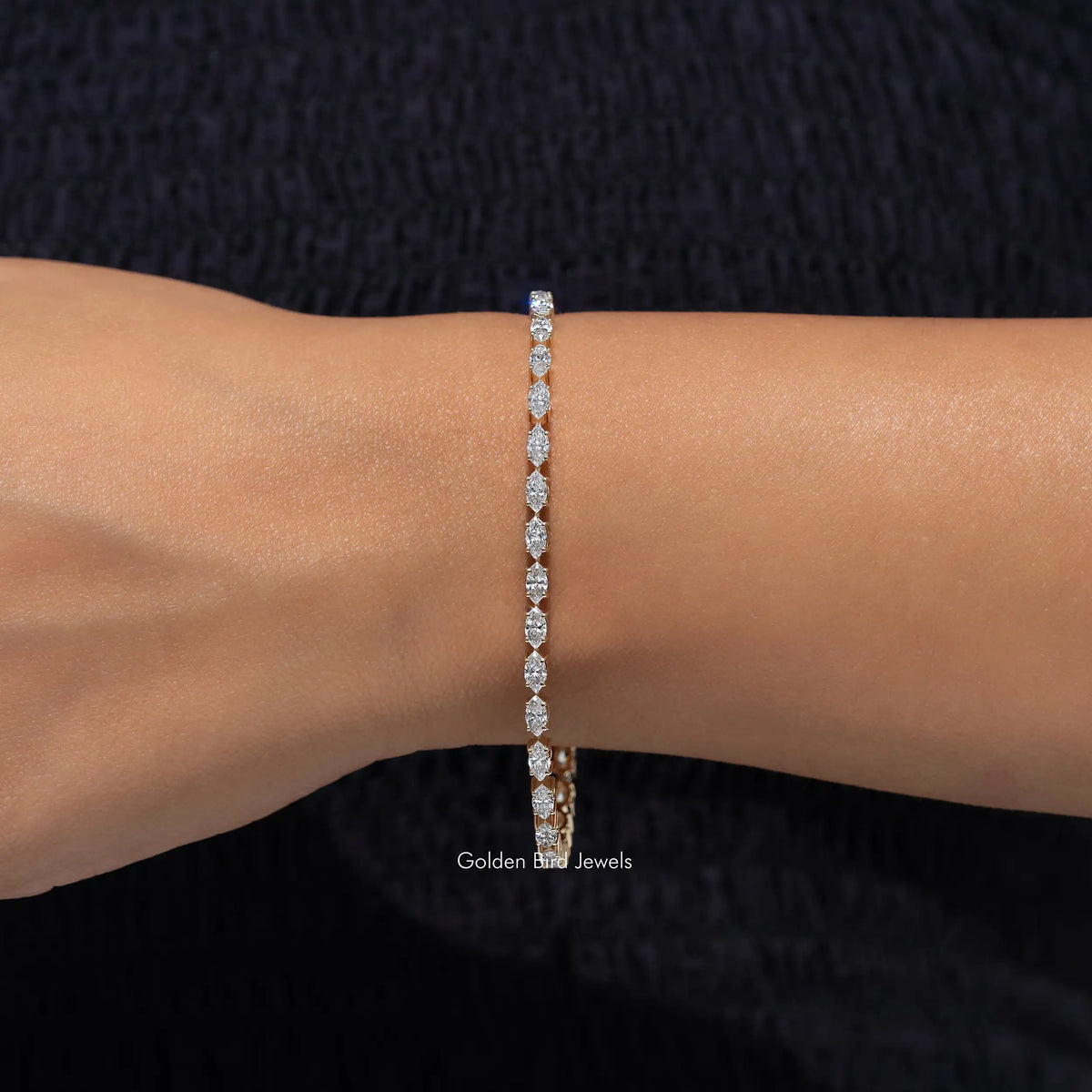 Lab-grown diamond tennis bracelet with marquise-cut stones, wrist shot with arm extended