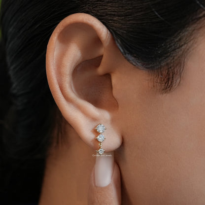Gold-tone three-round-stone stud earring with round lab diamonds, side view