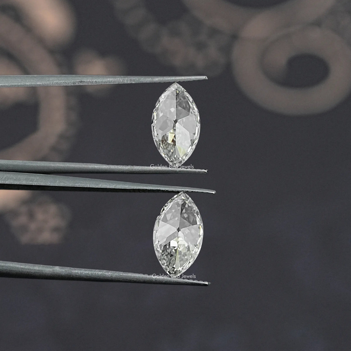 Marquise-cut lab-grown diamond pair shown from the side on metal prongs
