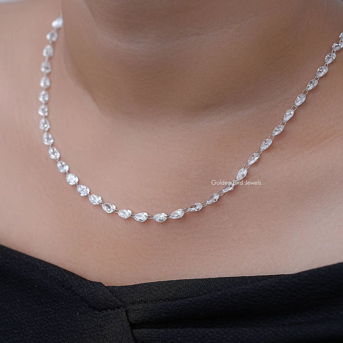 Silver pear-cut diamond tennis necklace on neckline, side view