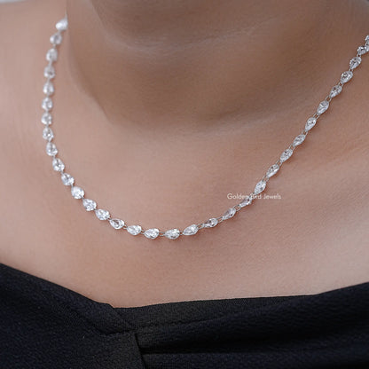 Silver pear-cut diamond tennis necklace on neckline, side view