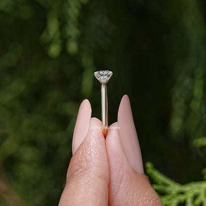 Three-stone round diamond engagement ring showing center stone in a six-prong setting