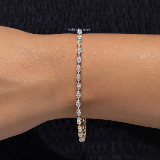 Gold-tone tennis bracelet with marquise-cut lab-grown diamonds on wrist, centered view