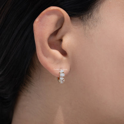 Gold-tone huggie hoop earrings with multi-shaped lab diamonds, close-up