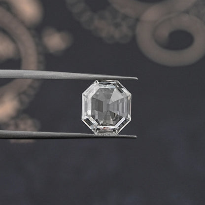 Lab-grown diamond old mine hexagon cut, close-up held by tweezers