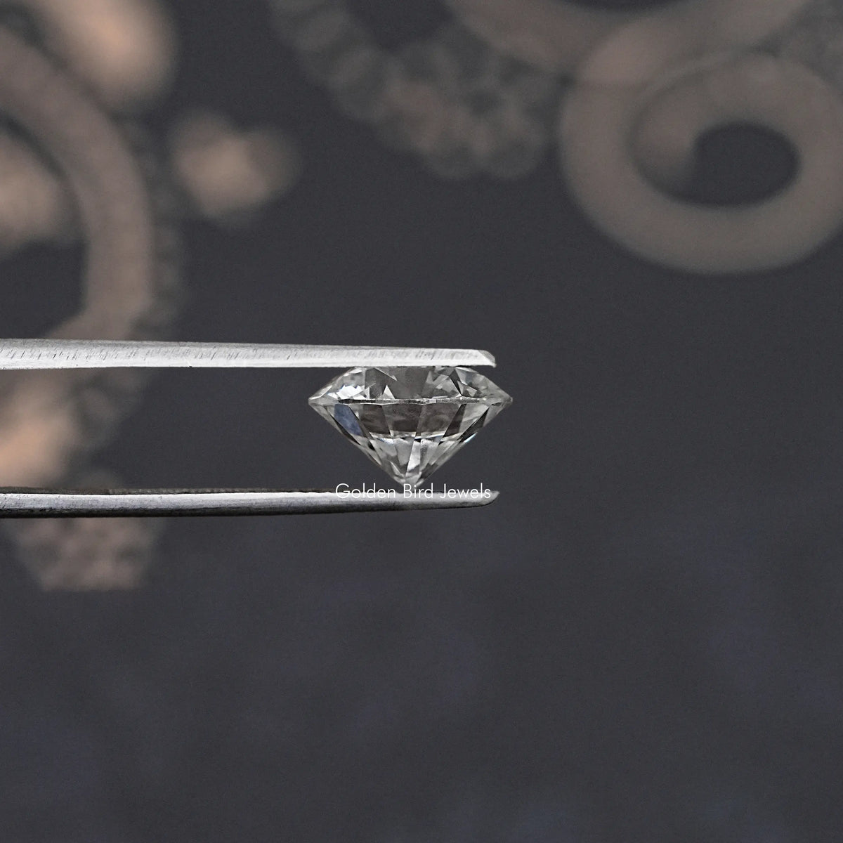 Loose round-cut lab diamond, facet side profile held in tweezers