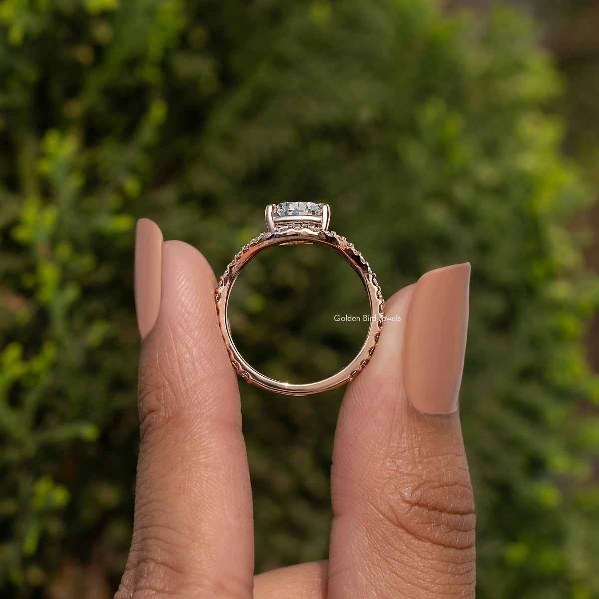 Pear-cut engagement ring with curved accent stones on a rose-gold tone band