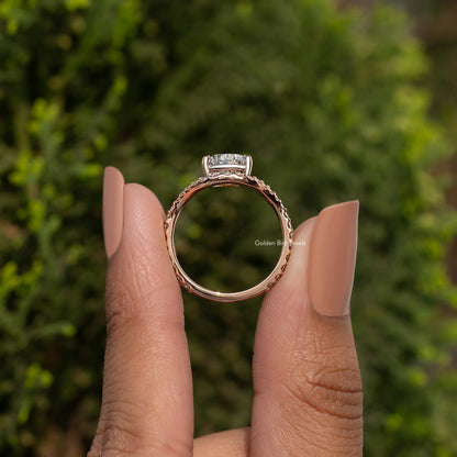 Pear-cut engagement ring with curved accent stones on a rose-gold tone band