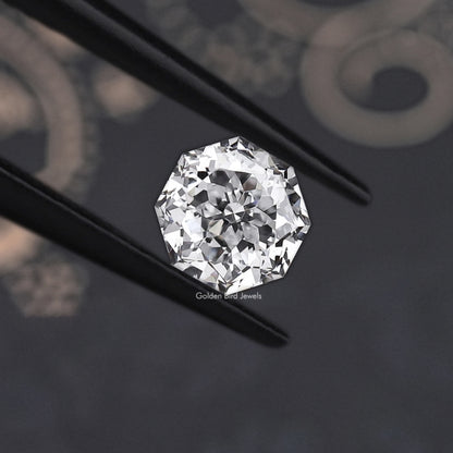 Faceted diamond close-up with reflective facets, angled setting view