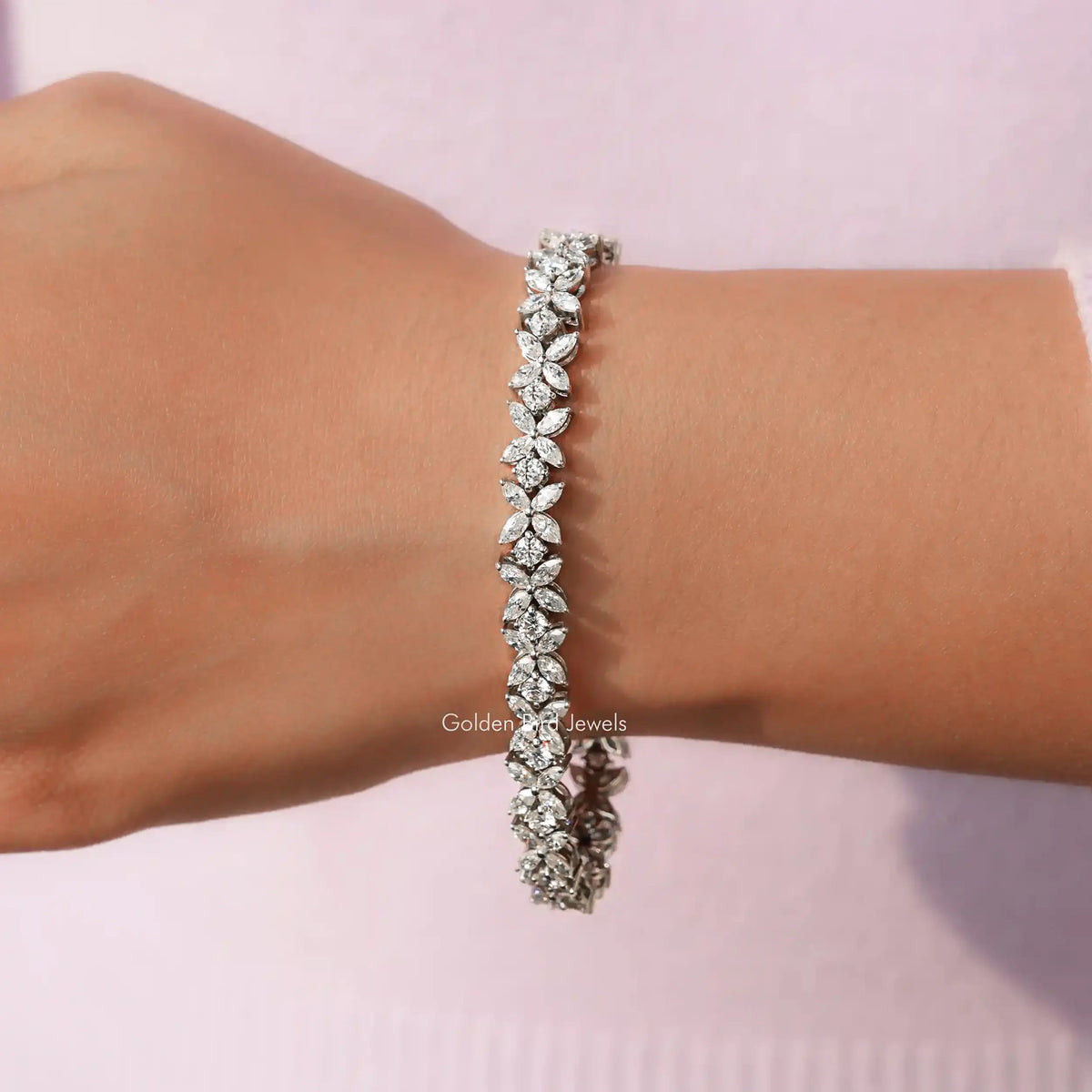 In hand View of Marquise And Round Cut Diamond Multi Stone Bracelet In White Gold