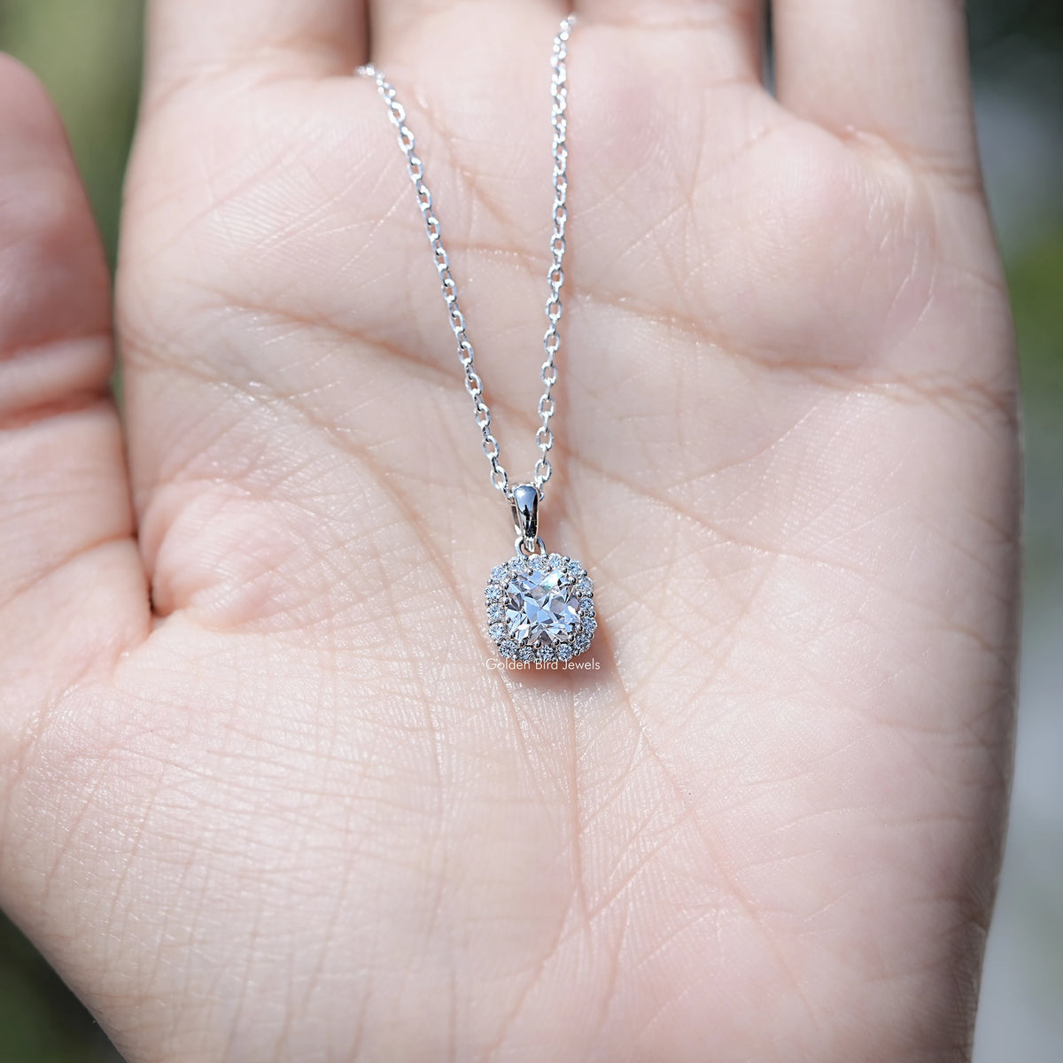 In Hand Showing of Old European Round Halo Lab Diamond Pendant