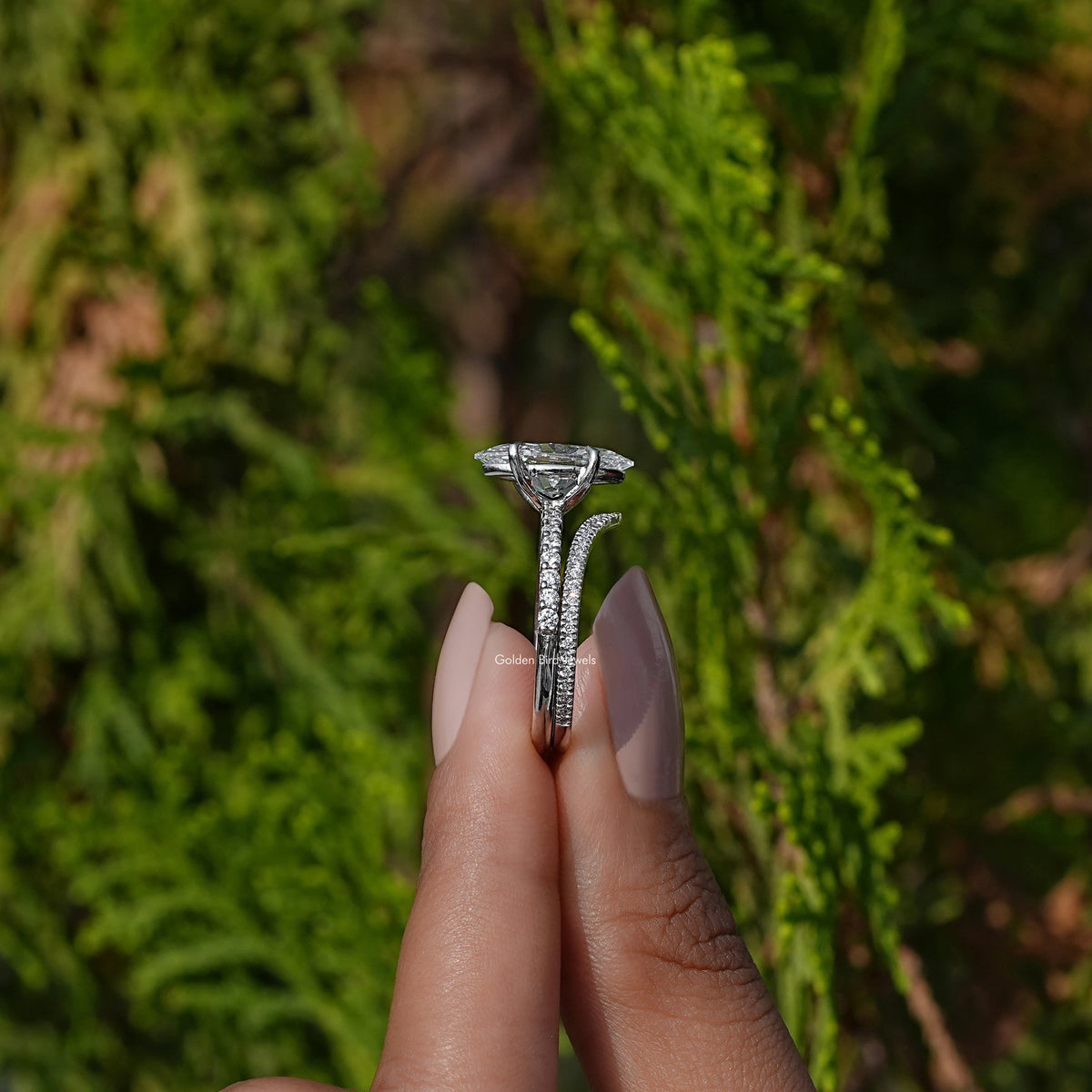 Side View of A Marquise Cut Bridal Ring Set in two fingers
