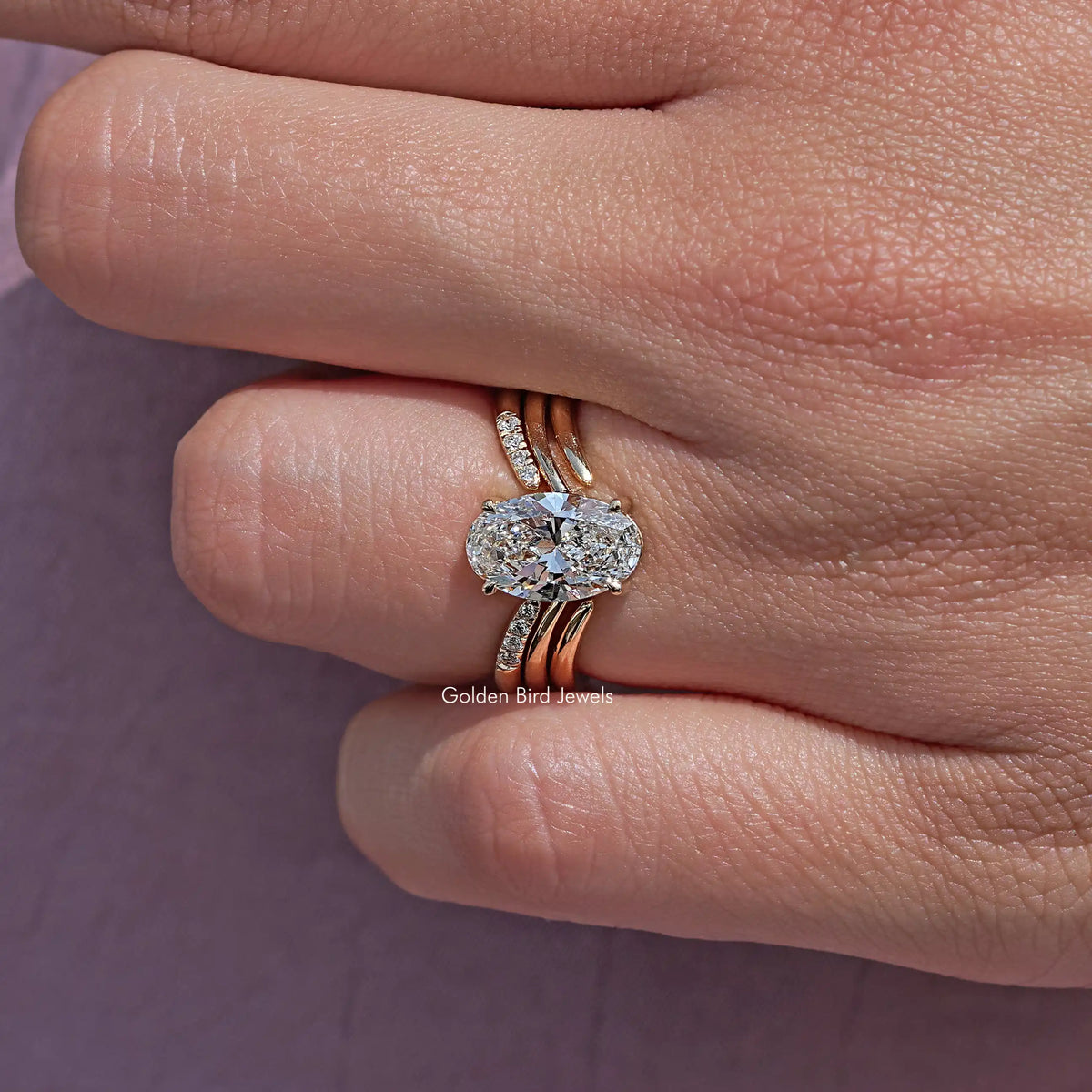 Oval lab diamond bridal ring with split-shank band and small side stones