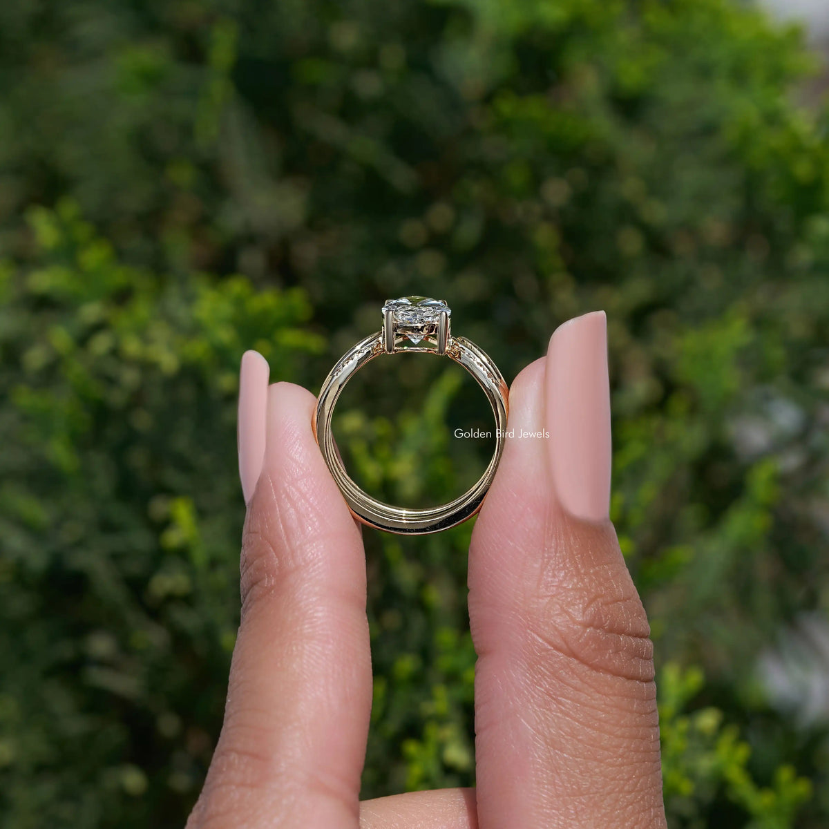 Gold-tone bridal ring set with oval lab diamond and side accent stones