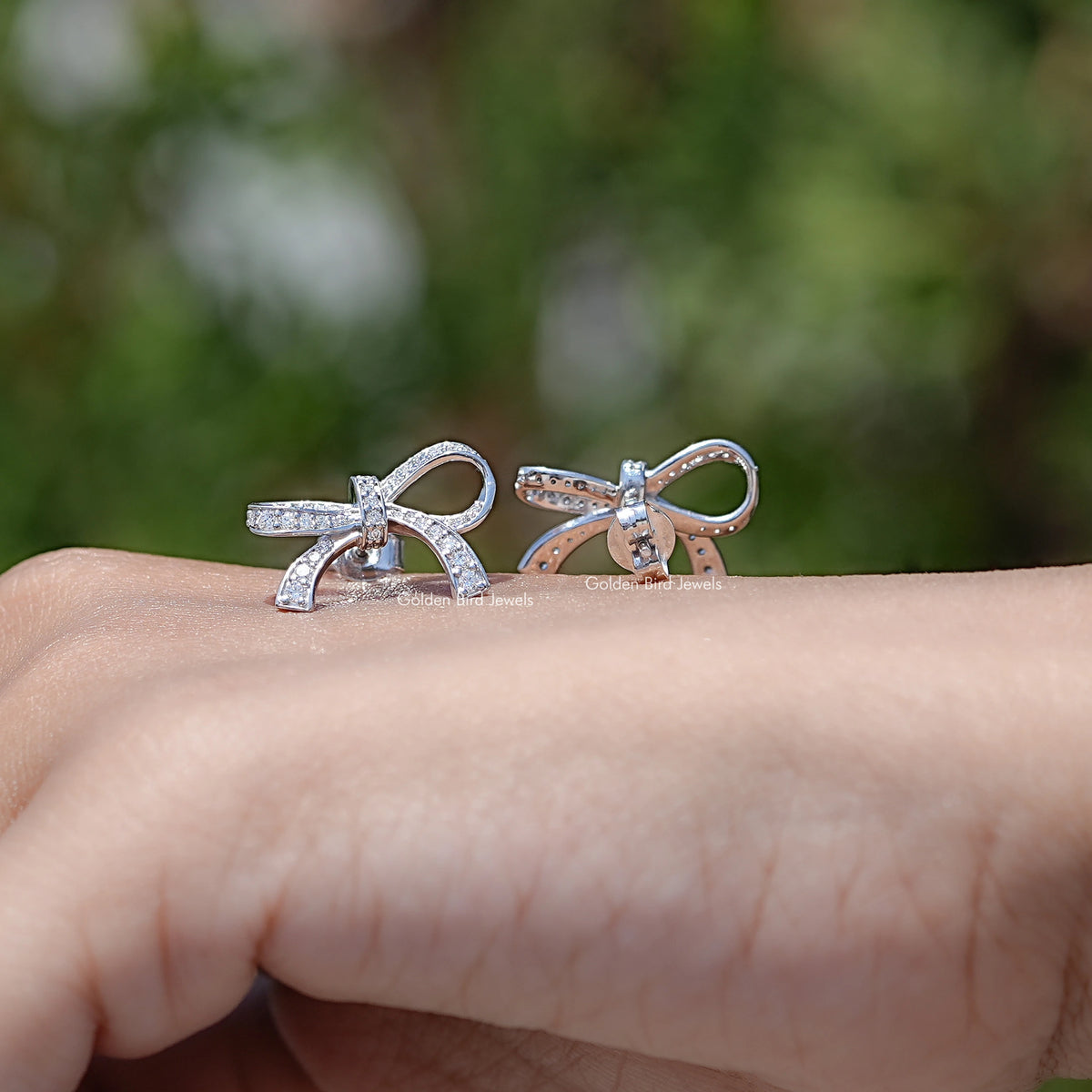 In Hand View Of Round Shaped Moissanite Stud Earrings 