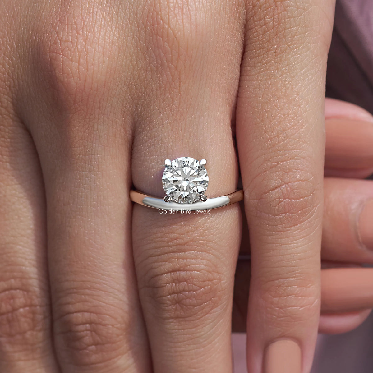 Silver solitaire ring with round lab diamond and curved band, close-up on hand