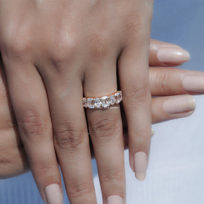 Seven-stone lab diamond ring on hand, showcasing oval-cut stone row