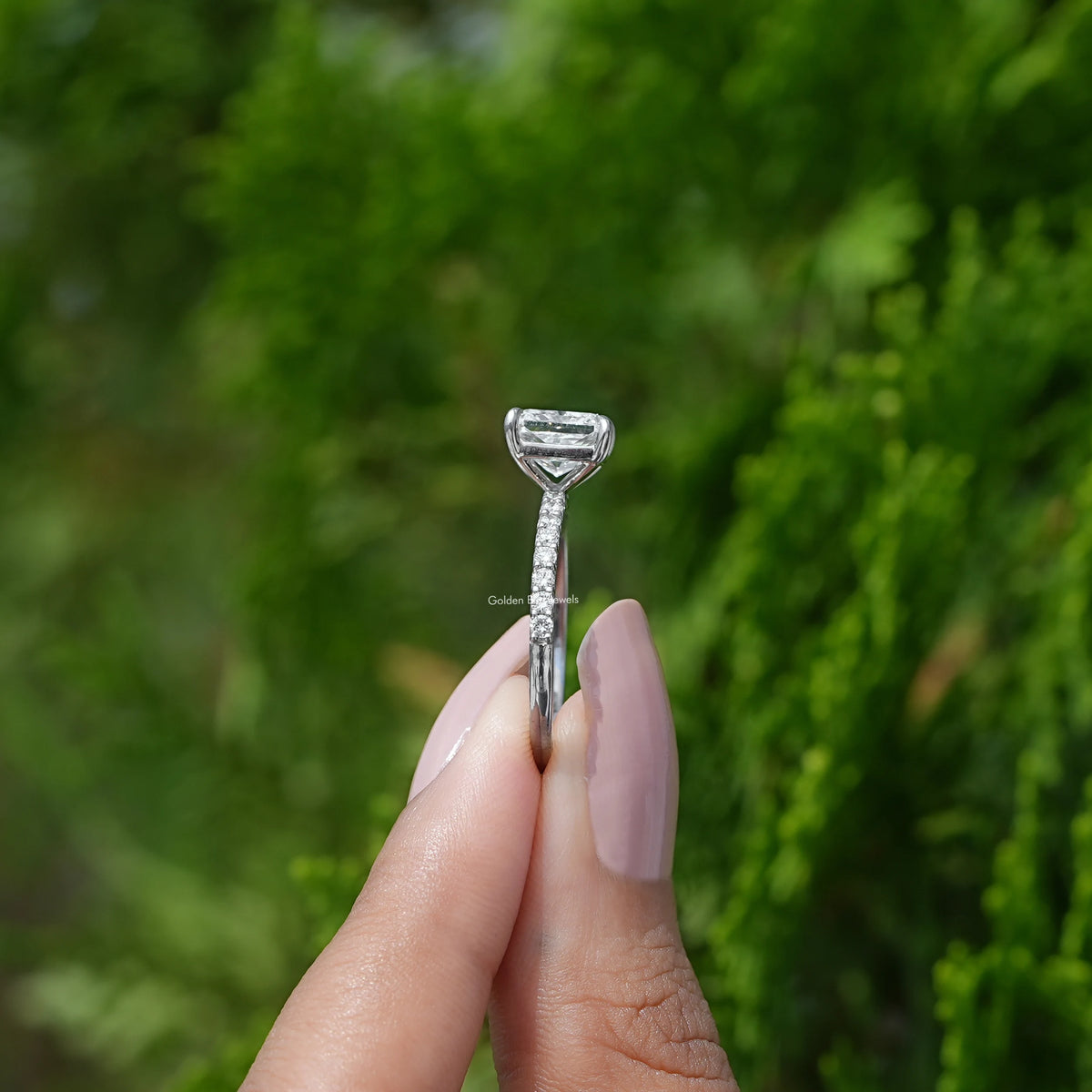 Side View of Radiant Cut Diamond Engagement Ring In two fingers