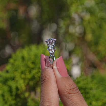 Lab gemstone engagement ring with pink center stone in prongs and leaf-like side details
