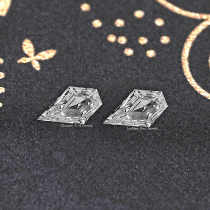 Two clear arrow-shaped lab-grown diamonds, close-up showing reflective facets