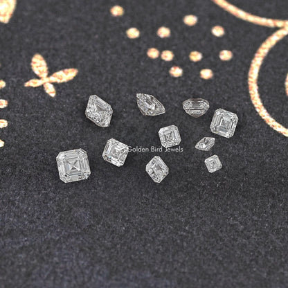 Asscher-cut lab diamonds scattered on dark jewelry display fabric, step-cut detail