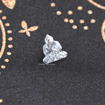 Lab-grown diamond on prongs, large triangular cluster cut close-up