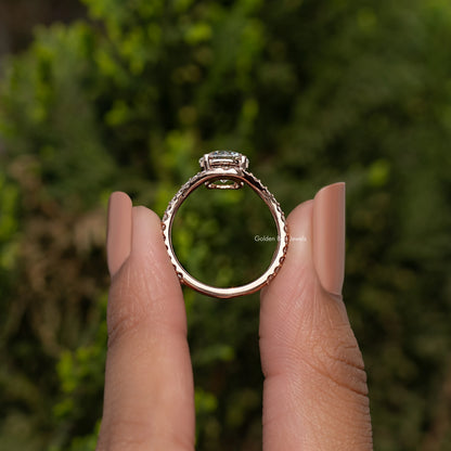Round-cut engagement ring with curved accent band, silver-toned setting