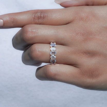 Close-up of a seven-stone lab diamond ring with oval-cut stones on band