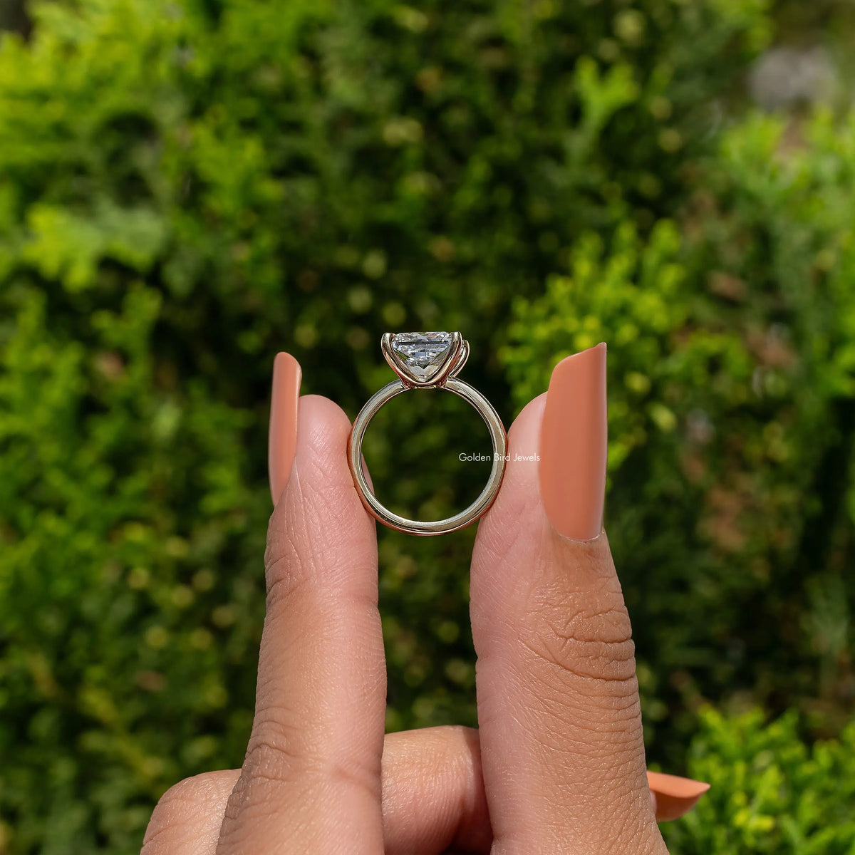 Princess-cut diamond solitaire ring, front view with round prong setting