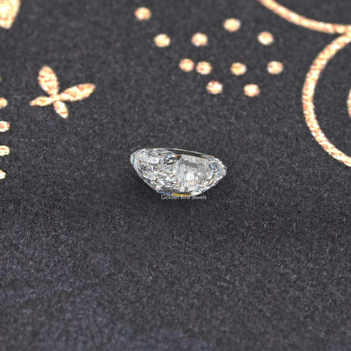 Duck-cut lab-grown diamond with pointed ends, stepped facets, close-up